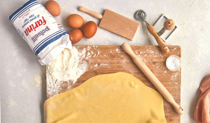 Pasta making tools laid out on a table with pasta dough | Pasta Evangelists
